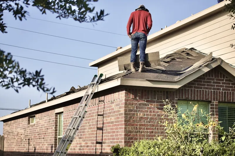 Professional roofer working on a residential roof in Galt